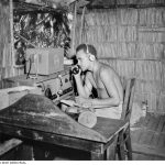 A local wireless telegraphist operator operating an AWA 3BZ teleradio at Segi Coastwatchers station, British Solomon Islands