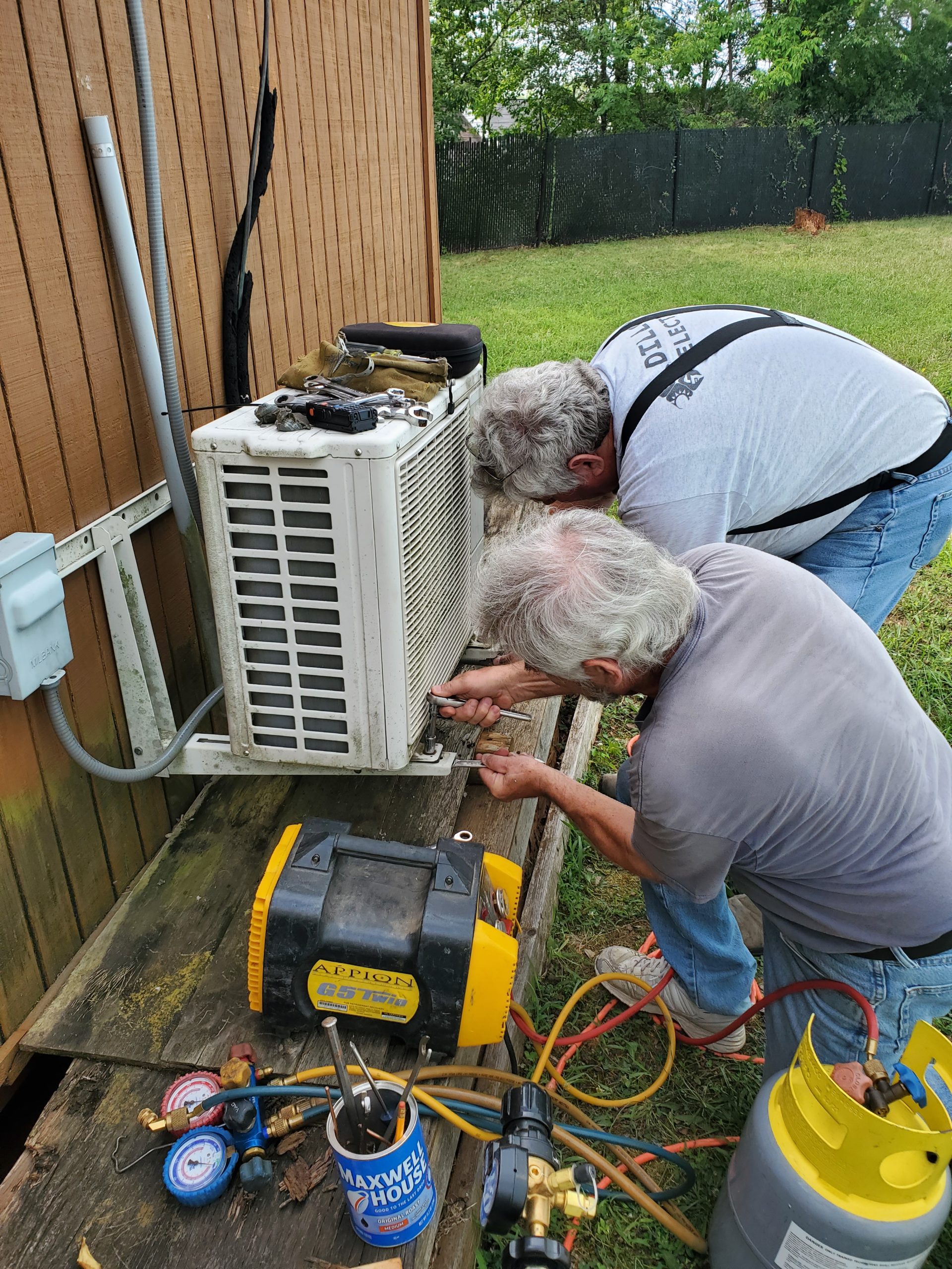 Gil KM4OZH and Byron AK4XR remove the old outside AC unit